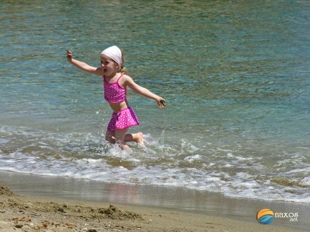 Child enjoying the sea at Moutsouna beach